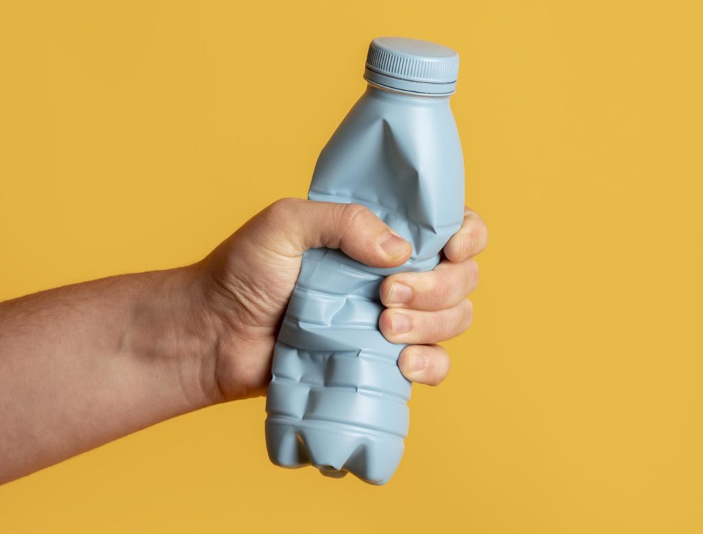 Bright plastic bottle crushed for recycling