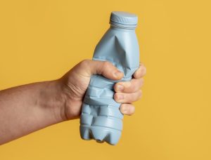 Bright plastic bottle crushed for recycling